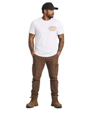 Man wearing a white t-shirt with a logo and brown pants on a white background