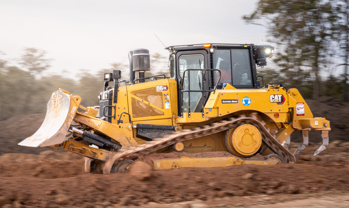 CAT D6XE electric-drive bulldozer moving earth on a worksite, photographed by Earthmoving Downunder