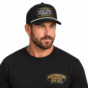 Close-up of the black Heritage T-shirt styled with the Heavy Iron Filming Co. SnapBack. SnapBack sold separately.