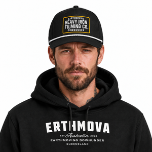 Model wearing the black Heavy Iron embroidered SnapBack and ERTHMOVA hoodie, front close-up. Hoodie sold separately.